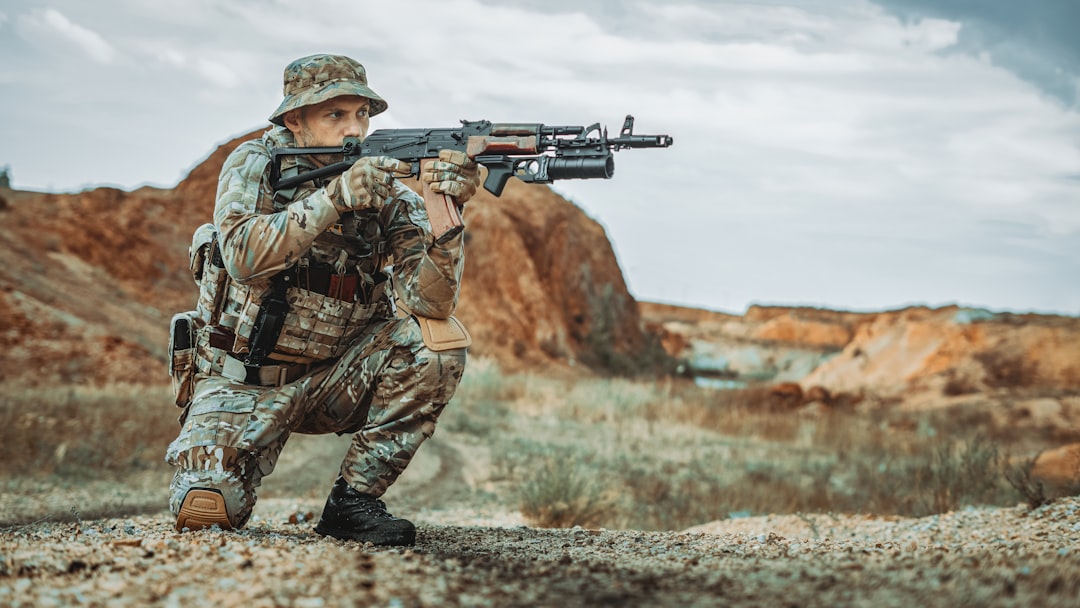 a-man-in-camouflage-holding-a-machine-gun-tdu1yxlob-i